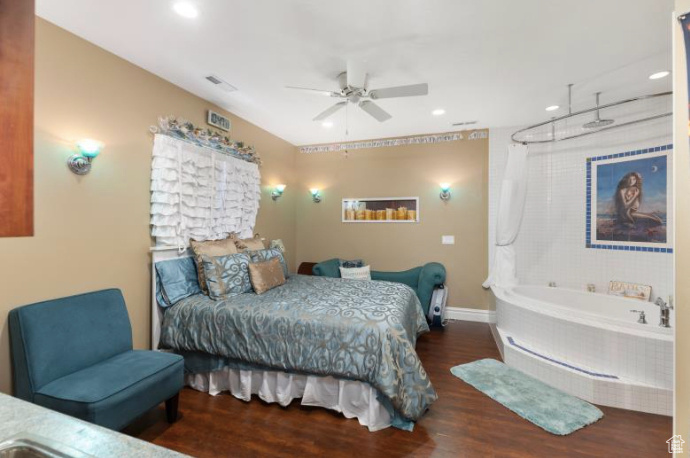 Bedroom with ceiling fan and dark hardwood / wood-style flooring