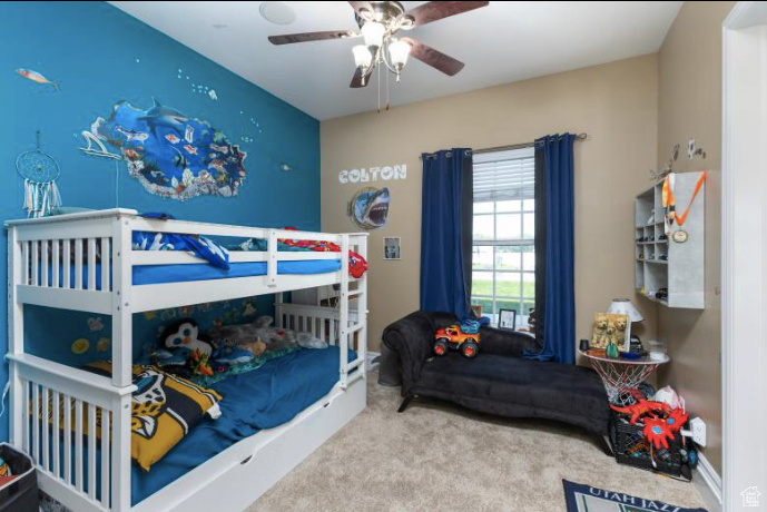 Bedroom featuring ceiling fan and carpet floors