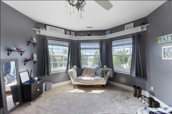 Sitting room with carpet flooring and ceiling fan