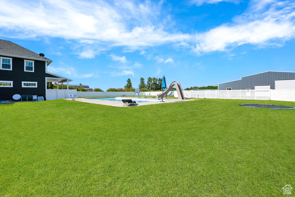 View of yard featuring a patio and a fenced in pool