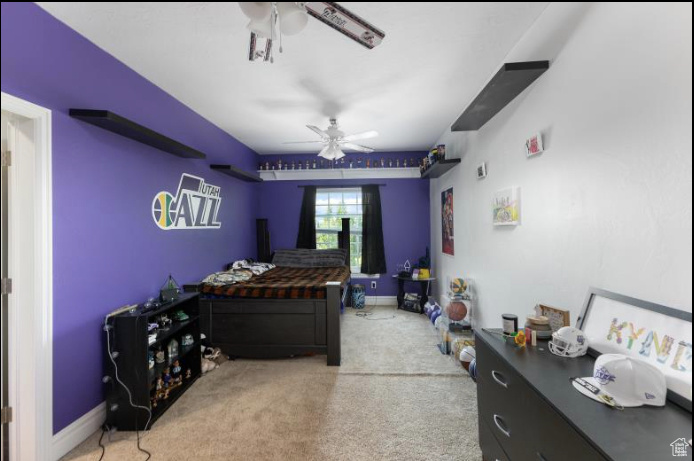 Carpeted bedroom with ceiling fan