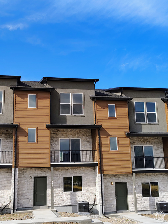 Exterior space featuring a balcony and central AC unit