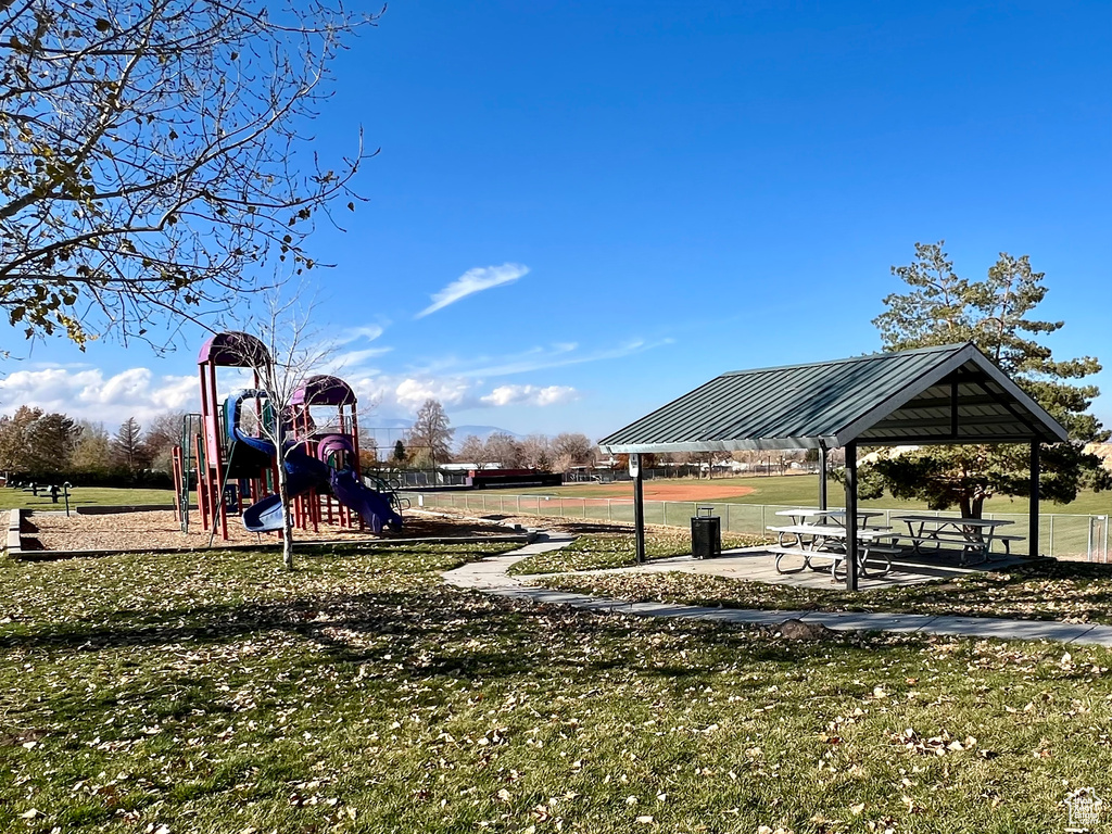 View of play area with a lawn and a gazebo