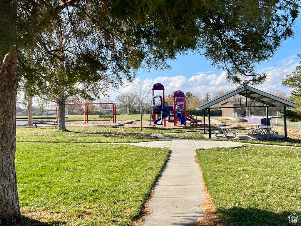 View of jungle gym featuring a lawn