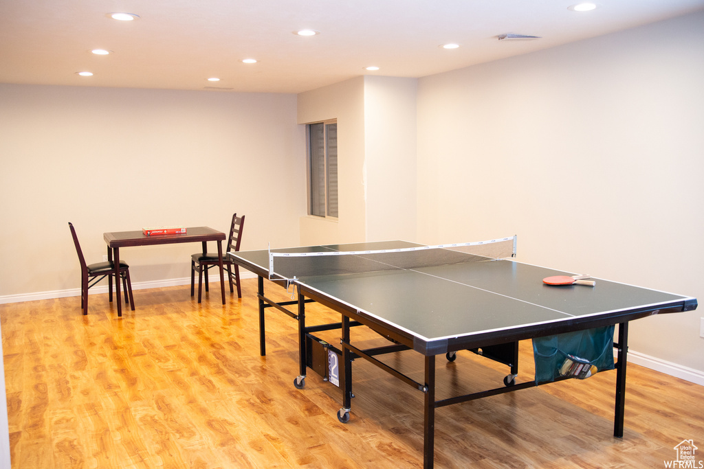 Recreation room with light hardwood / wood-style flooring