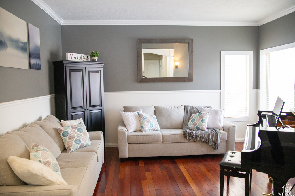 Living room with dark wood-type flooring and crown molding