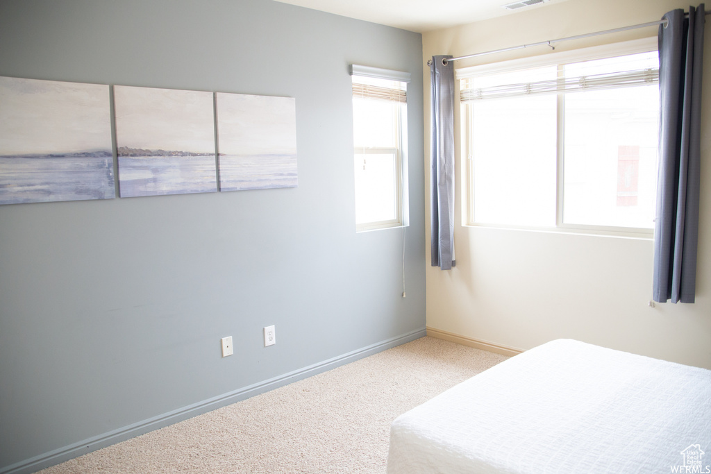 Unfurnished bedroom with carpet floors