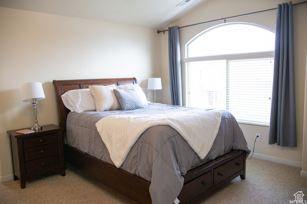 Carpeted bedroom with vaulted ceiling