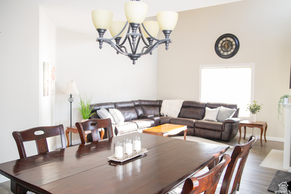 Dining room with an inviting chandelier and hardwood / wood-style floors