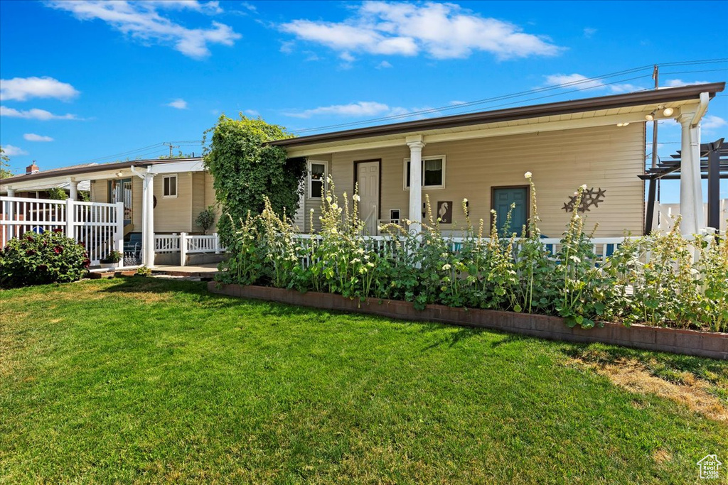 Rear view of property featuring a yard