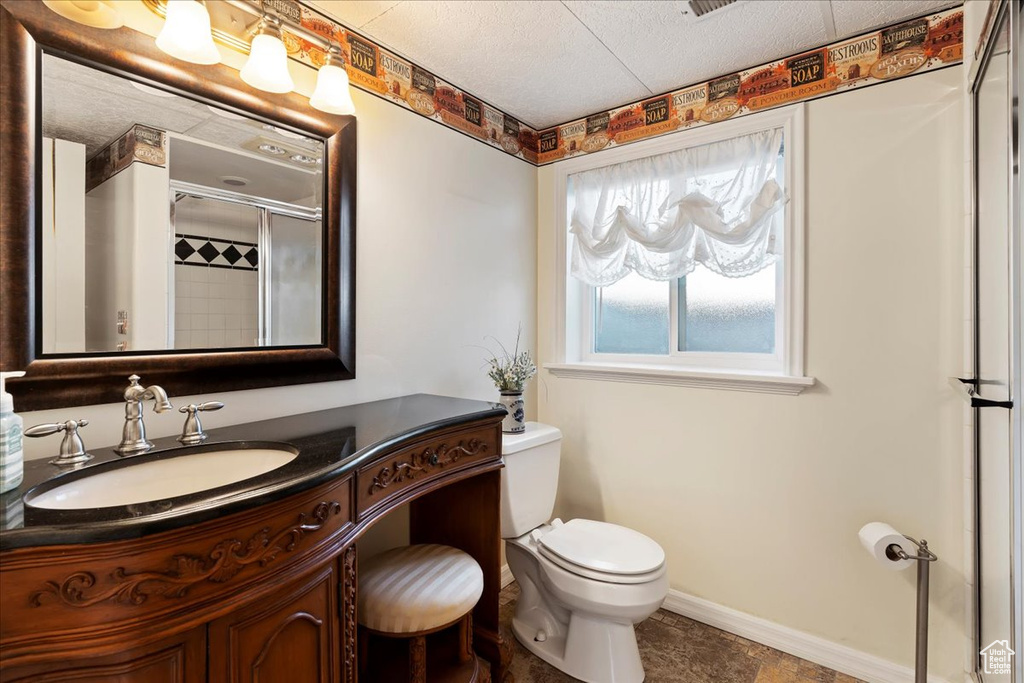 Bathroom featuring vanity, toilet, and tile patterned floors