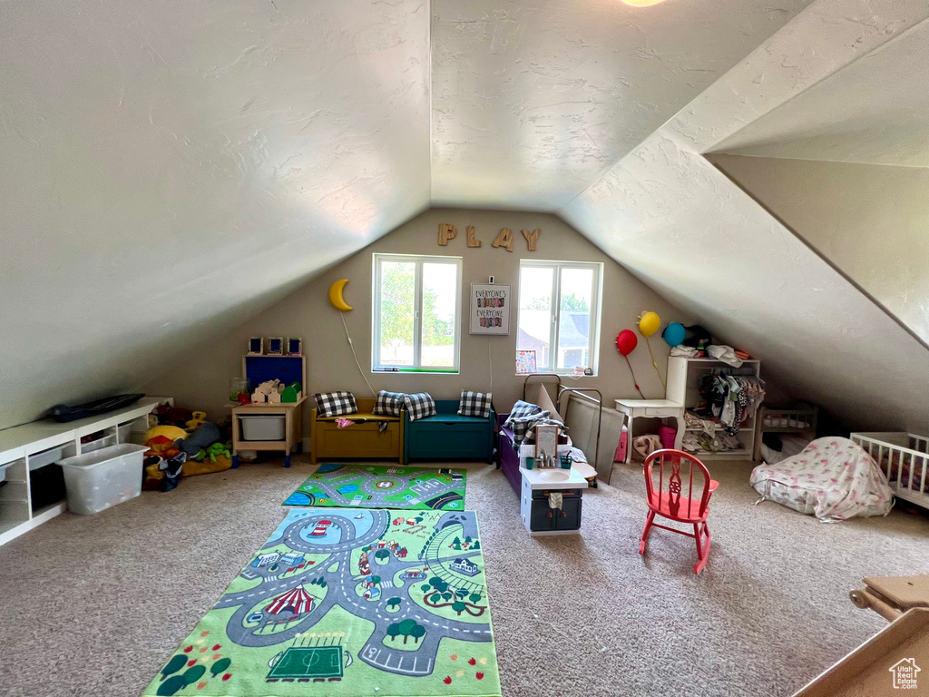 Playroom with carpet floors and lofted ceiling