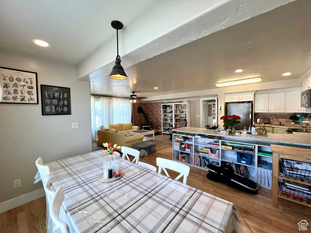 Dining room featuring wood-type flooring and ceiling fan