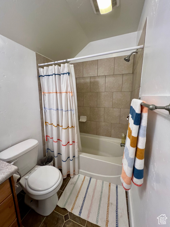 Full bathroom with vanity, shower / tub combo with curtain, toilet, and tile patterned flooring