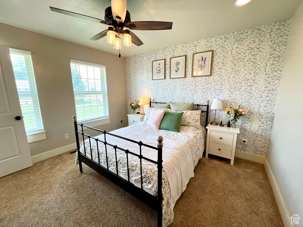 Carpeted bedroom with ceiling fan