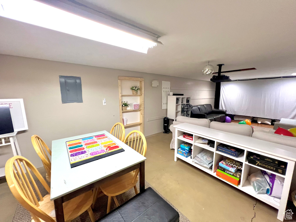 Dining space featuring concrete flooring and electric panel