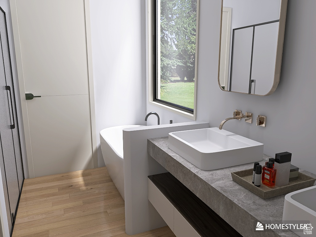 Bathroom with wood-type flooring, vanity, and a bathtub