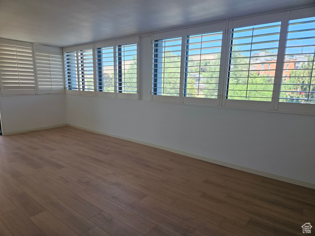 Unfurnished room with hardwood / wood-style flooring