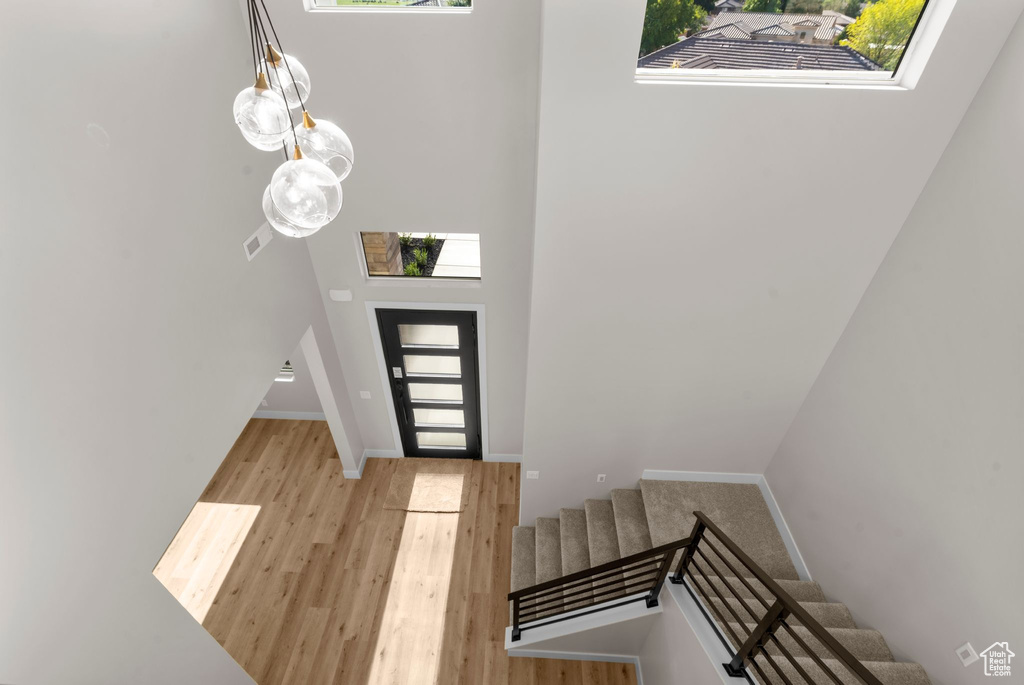 Foyer with a high ceiling and light hardwood / wood-style floors