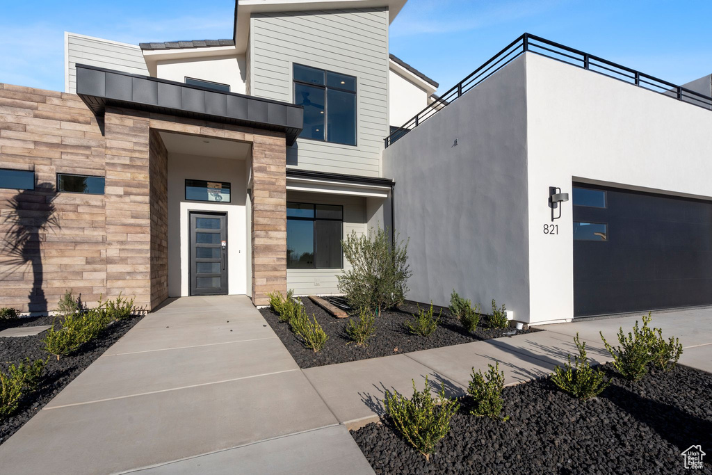 Doorway to property featuring a garage