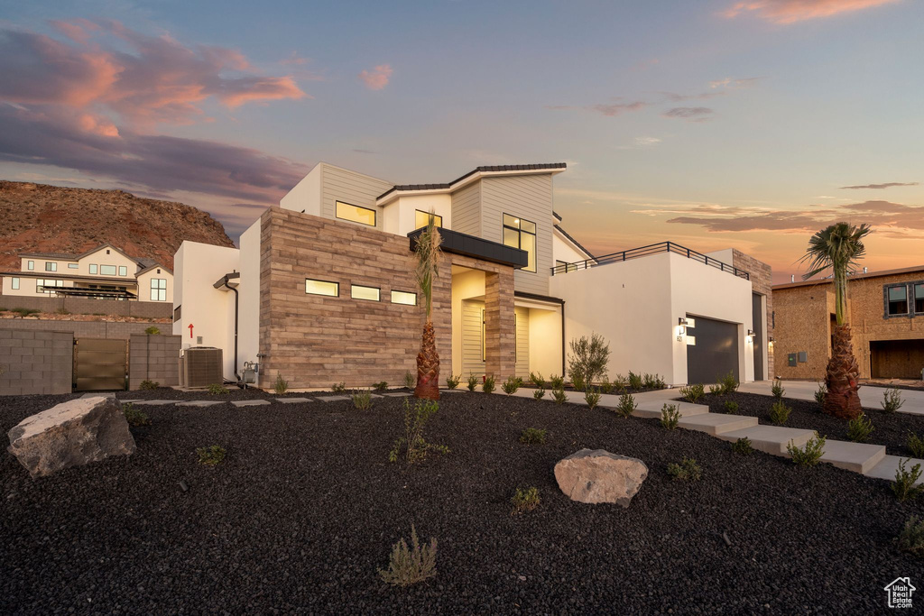 Contemporary home with a garage and central AC unit