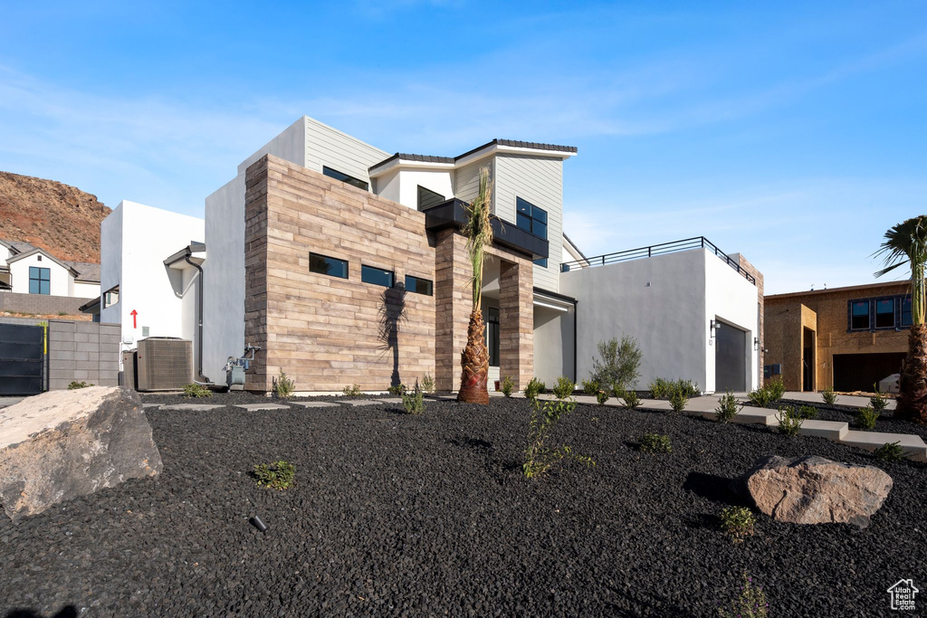 Exterior space with central AC and a garage