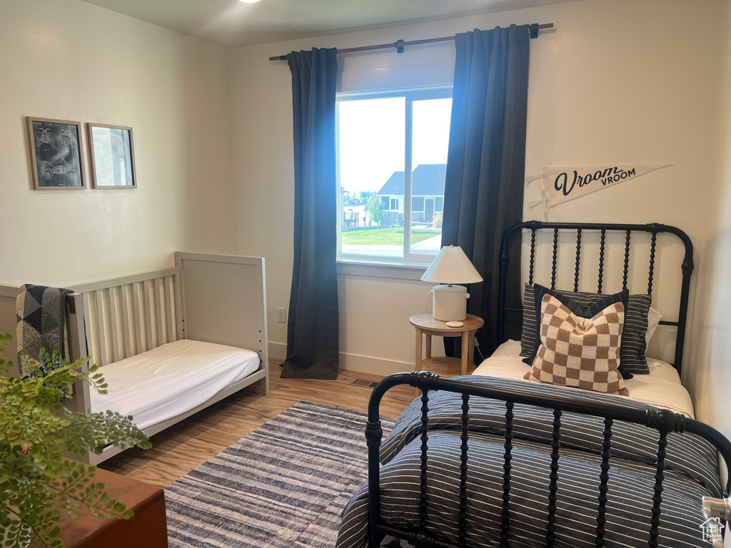 Bedroom with hardwood / wood-style floors