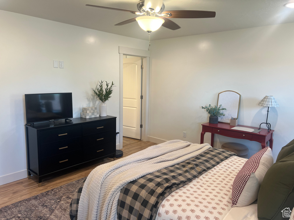 Bedroom with hardwood / wood-style flooring and ceiling fan