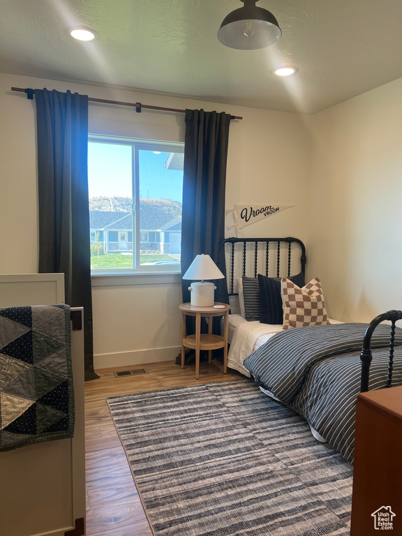 Bedroom with wood-type flooring