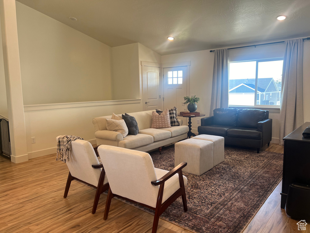 Living room featuring hardwood / wood-style flooring and lofted ceiling