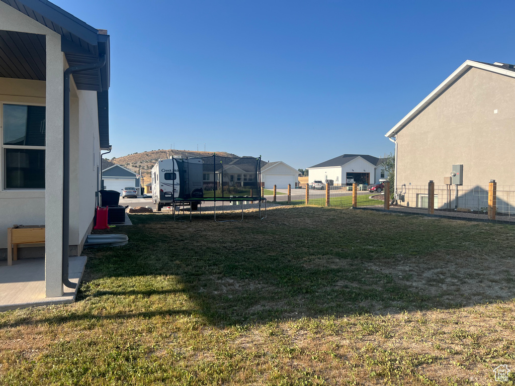 View of yard with a trampoline