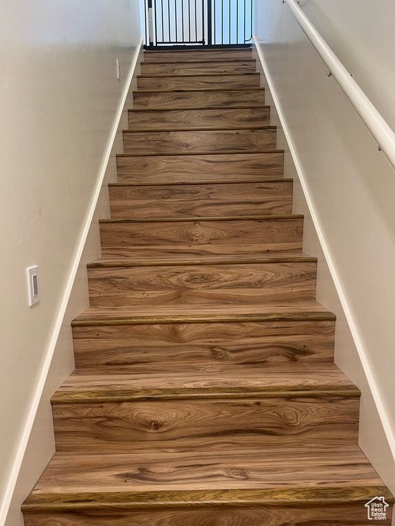 Stairway featuring hardwood / wood-style floors