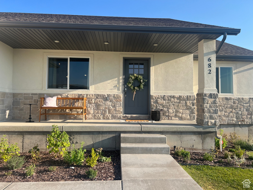 View of exterior entry with central AC unit