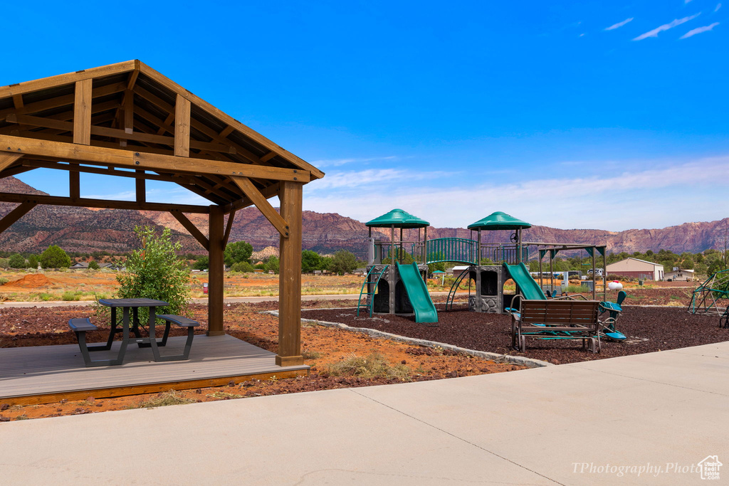 View of jungle gym featuring a mountain view