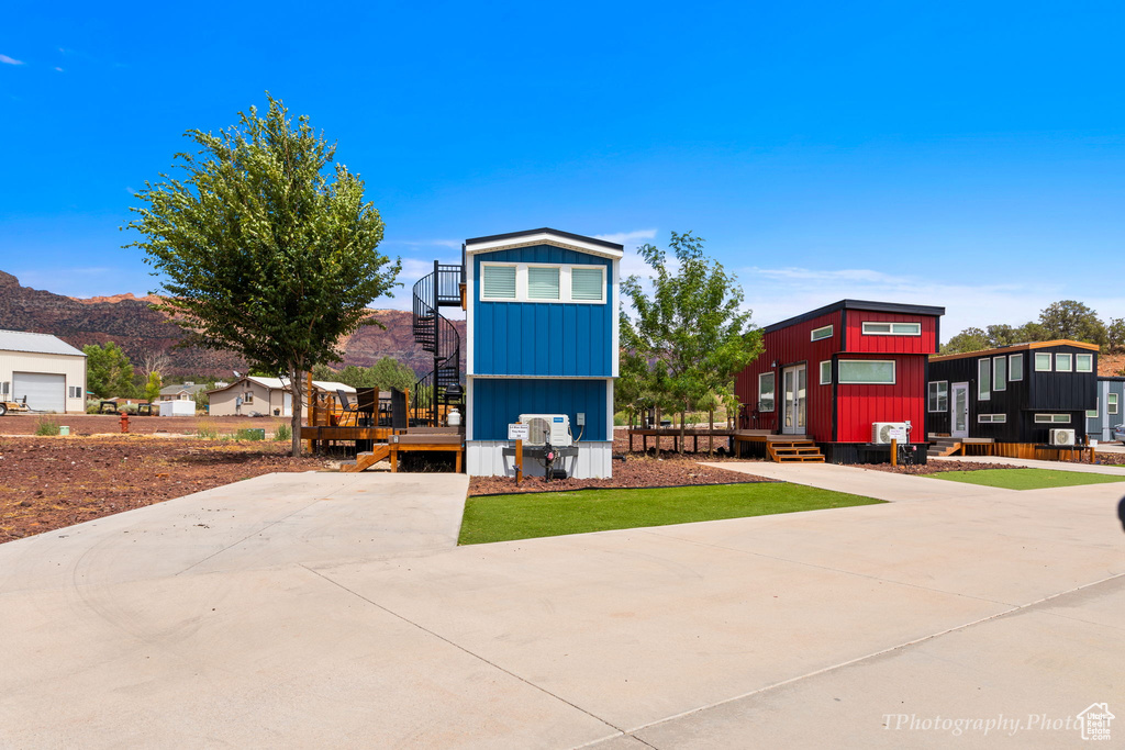 View of front of house with a wooden deck
