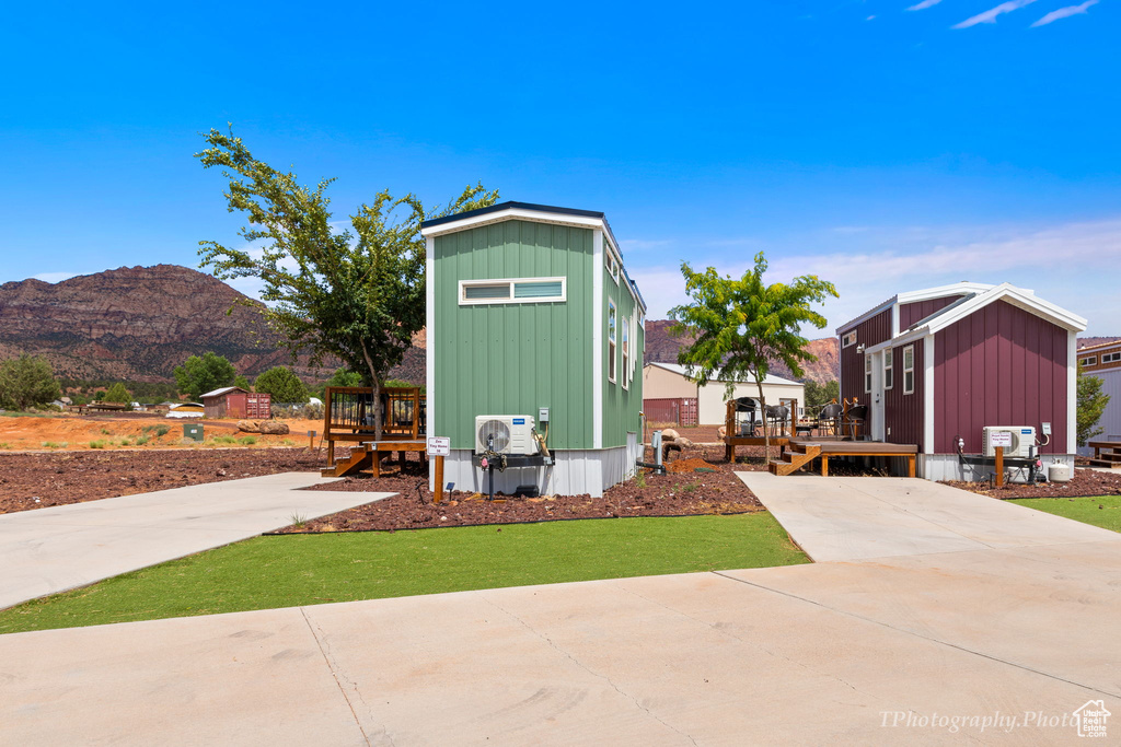 View of outbuilding featuring a mountain view and a yard