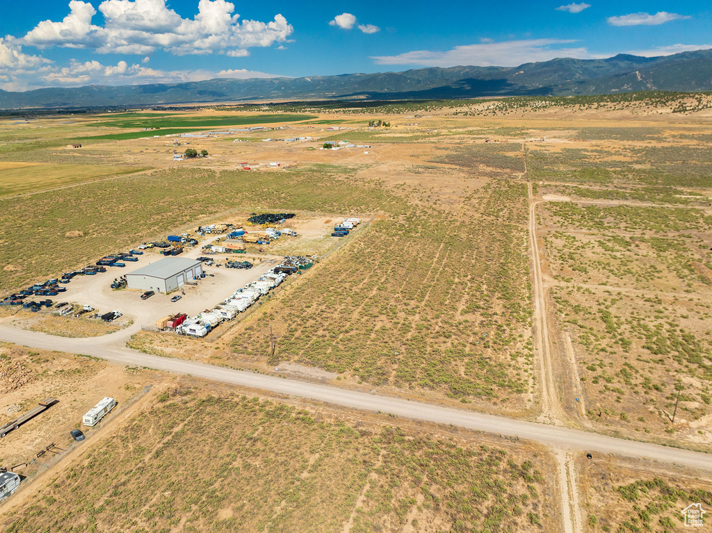 Birds eye view of property with a rural view and a mountain view