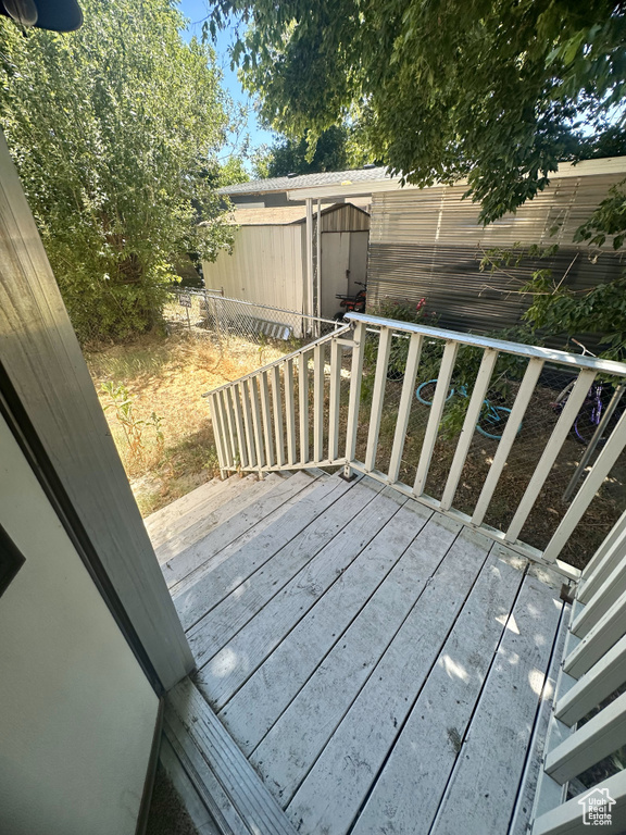 Wooden terrace featuring a shed