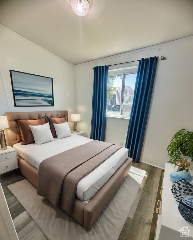 Bedroom with hardwood / wood-style flooring