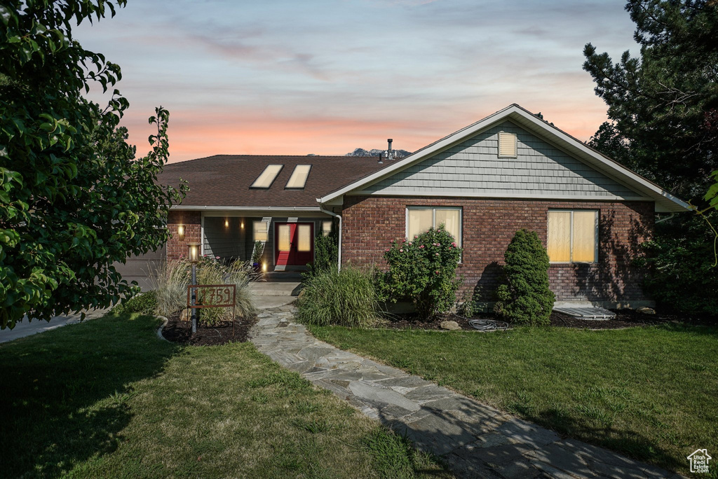 View of front of home featuring a yard