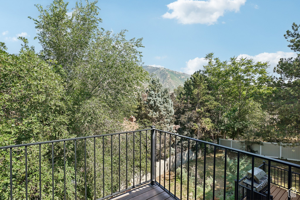 Balcony featuring a mountain view and area for grilling