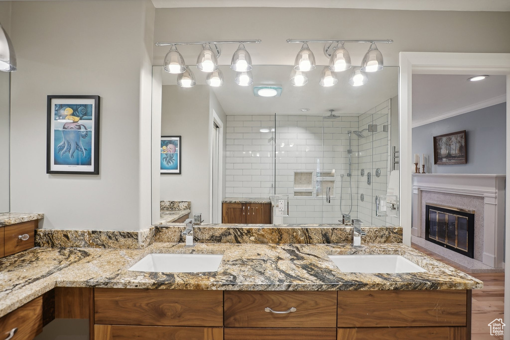 Bathroom featuring crown molding, hardwood / wood-style floors, vanity, and an enclosed shower