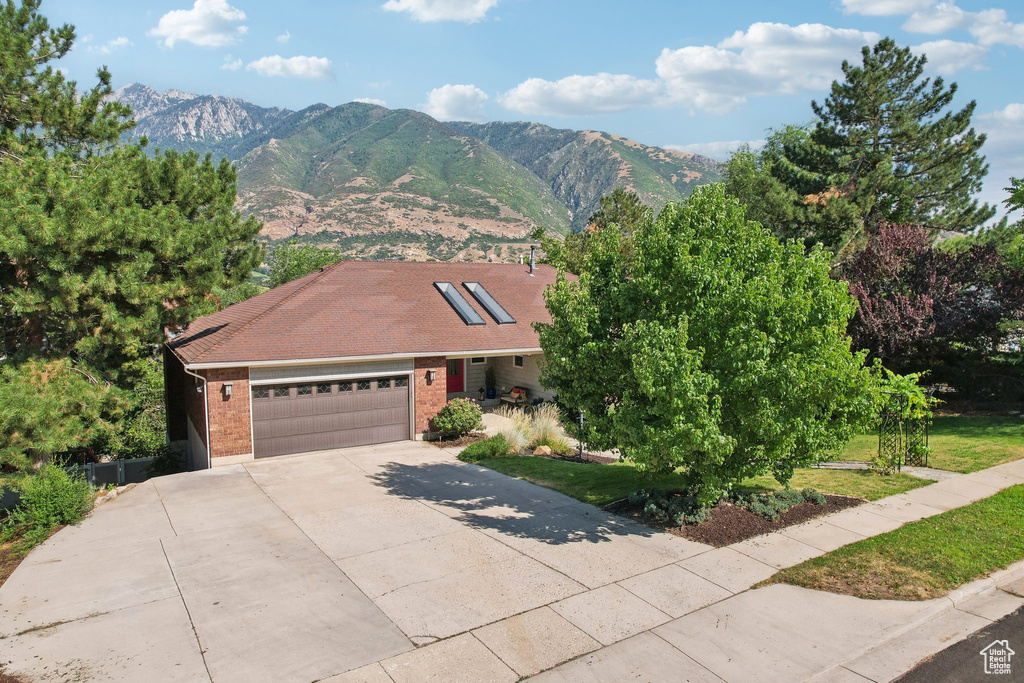 View of front of property featuring a garage and a mountain view