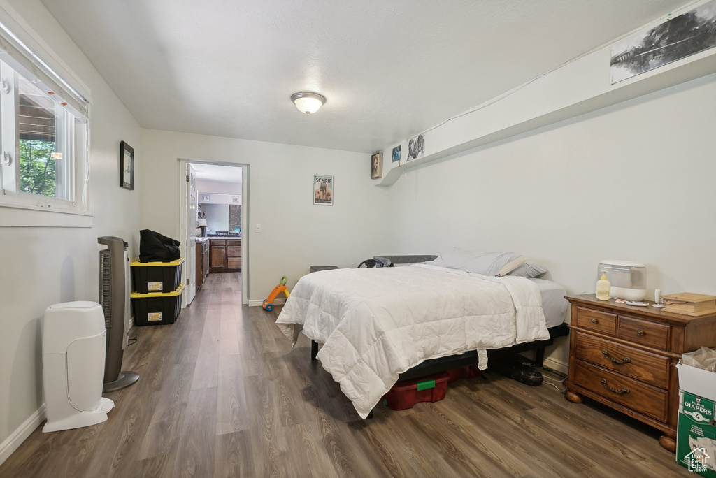 Bedroom with dark wood-type flooring