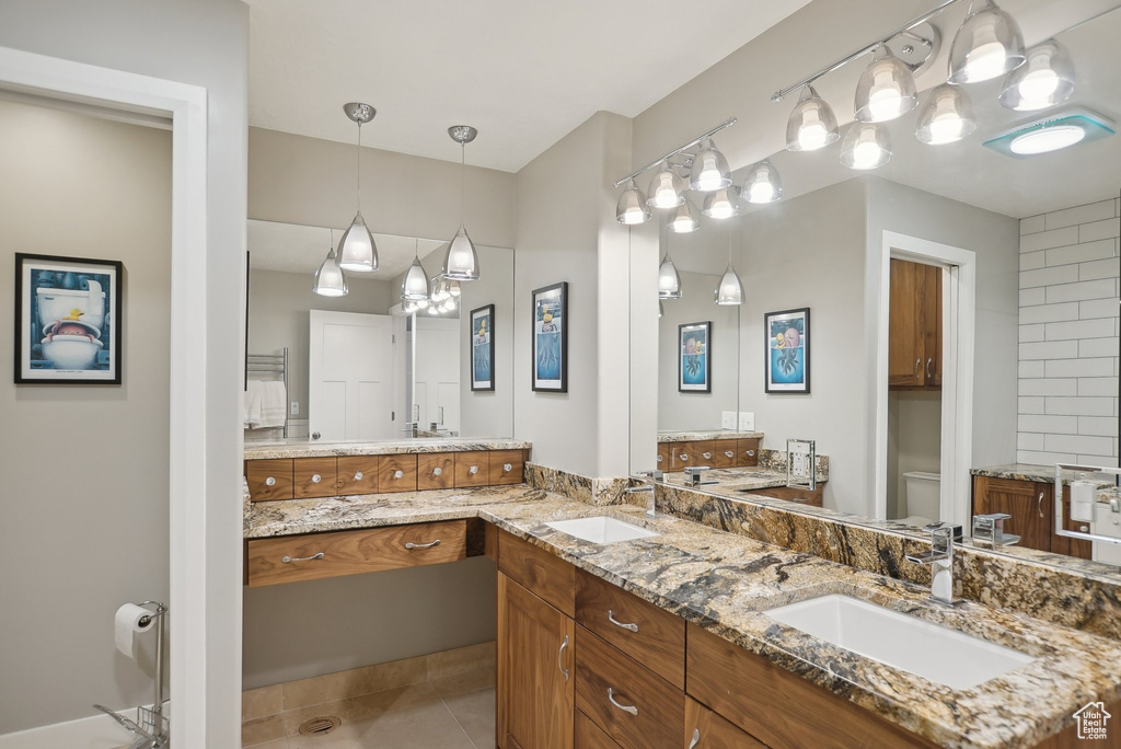 Bathroom with tile patterned flooring and dual bowl vanity