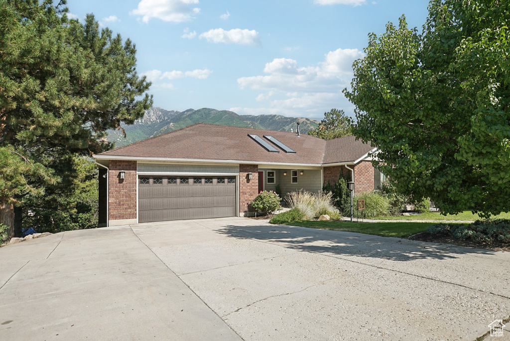 Ranch-style house with a mountain view and a garage