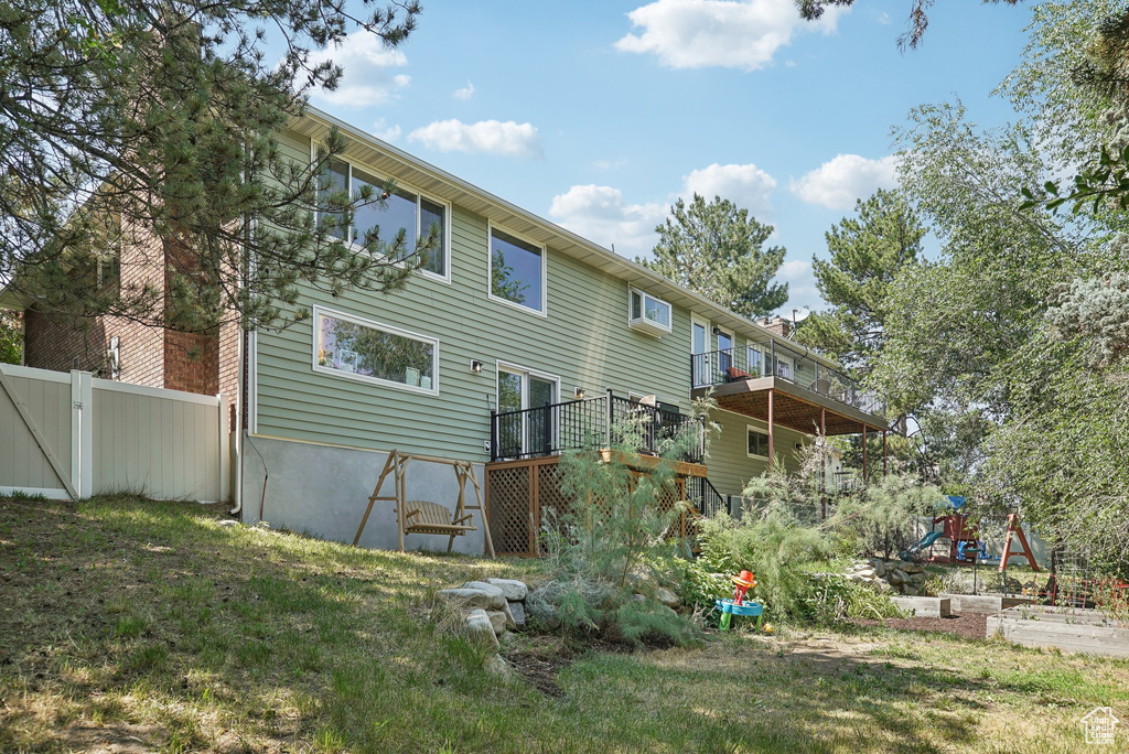 Rear view of house with a yard