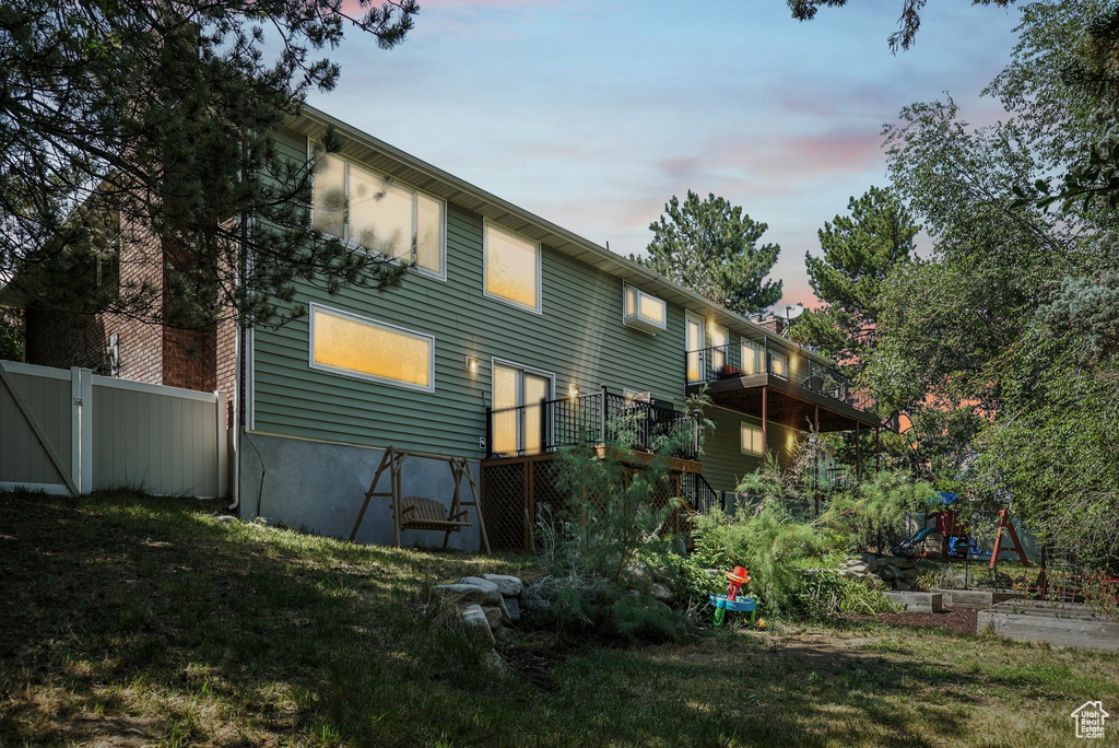 Back house at dusk with a lawn