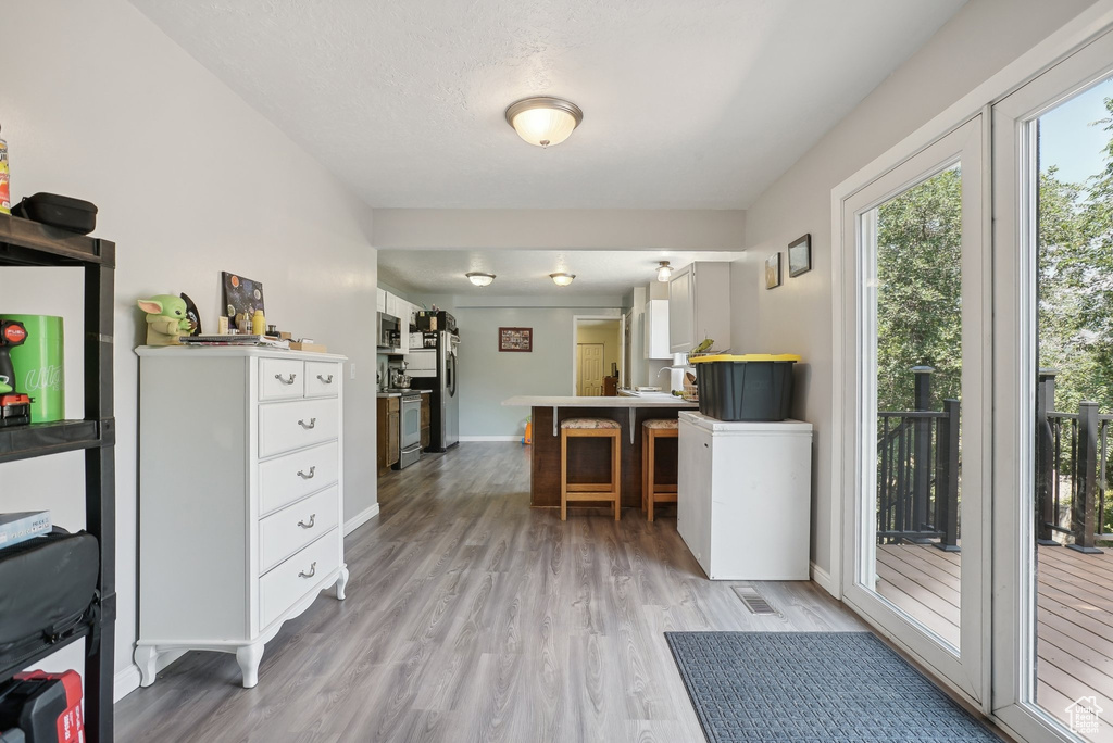 Office space with light hardwood / wood-style flooring