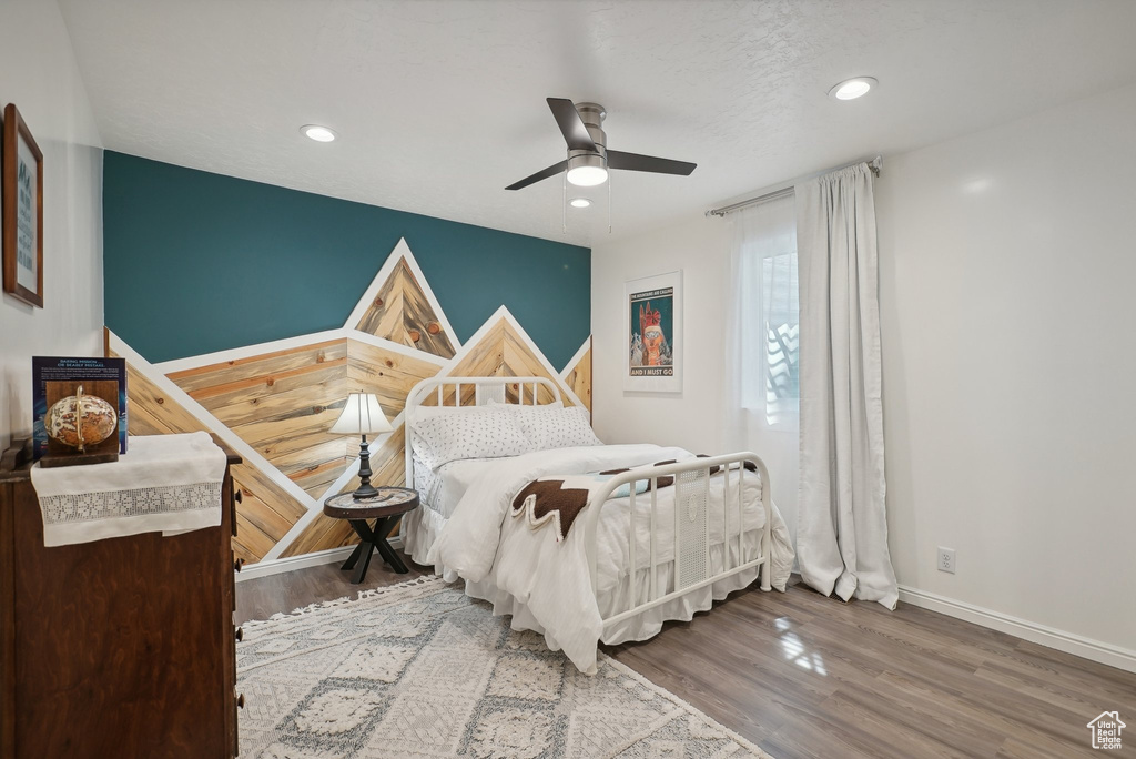 Bedroom with light hardwood / wood-style flooring and ceiling fan